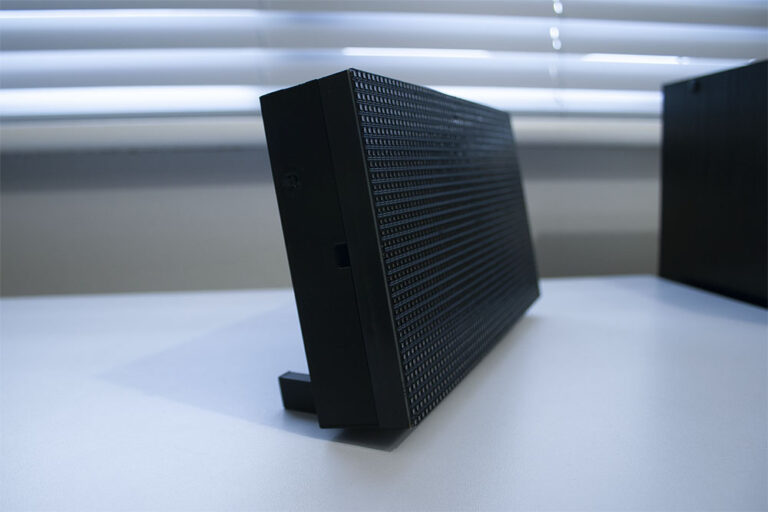Side profile of the ticker's custom case and detachable desk leg